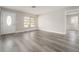 Bright living room featuring modern gray wood-look flooring and neutral paint colors at 14464 Sw 34Th Terrace Rd, Ocala, FL 34473