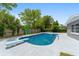 An eye-catching pool with a diving board and mature landscaping, perfect for relaxing and entertaining at 14464 Sw 34Th Terrace Rd, Ocala, FL 34473
