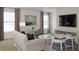 Bright living room with large windows, neutral decor, a comfortable sofa, and a modern entertainment center at 2437 Spring Tune Aly, Kissimmee, FL 34744