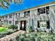 Exterior view of building, landscaping, brick facade, and updated windows with black shutters at 296 Lewfield Cir, Winter Park, FL 32792