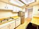 Kitchen with stainless steel appliances, wood counters, and white cabinets at 296 Lewfield Cir, Winter Park, FL 32792