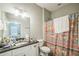 Bathroom with vanity and shower with a patterned curtain at 3184 Whispering Trails Ave, Winter Haven, FL 33884