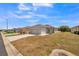 Lovely single-Gathering home featuring a spacious yard, a two-car garage, and classic architectural details at 3184 Whispering Trails Ave, Winter Haven, FL 33884
