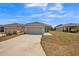 Inviting single-Gathering home featuring a well-maintained lawn, a two-car garage, and a welcoming entrance at 3184 Whispering Trails Ave, Winter Haven, FL 33884