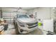 Garage with a new silver car and a white washer and dryer at 3184 Whispering Trails Ave, Winter Haven, FL 33884