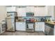 Functional kitchen equipped with stainless steel appliances, ample counter space, and a convenient layout at 3184 Whispering Trails Ave, Winter Haven, FL 33884