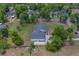 An aerial view of a house with a lush lawn and trees, in a serene neighborhood at 4004 Se 47Th Pl, Ocala, FL 34480
