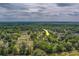 Expansive aerial view showcasing the home nestled within lush trees, featuring a spacious yard and serene setting at 4004 Se 47Th Pl, Ocala, FL 34480