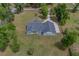 A charming home with a gray roof nestled among trees and an expansive lawn at 4004 Se 47Th Pl, Ocala, FL 34480