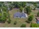 An overhead view of the house set on a sizable lot with mature trees and a long driveway at 4004 Se 47Th Pl, Ocala, FL 34480