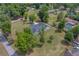 A captivating aerial view of the home on a verdant lot with mature trees and a winding driveway at 4004 Se 47Th Pl, Ocala, FL 34480