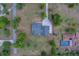 Aerial view of a home surrounded by lush greenery, showcasing its spacious layout and large driveway at 4004 Se 47Th Pl, Ocala, FL 34480