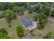 An aerial shot showcases this home on a lush lot with mature trees and a long driveway at 4004 Se 47Th Pl, Ocala, FL 34480