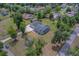 Aerial view of the home on an expansive lot, surrounded by lush greenery and mature trees at 4004 Se 47Th Pl, Ocala, FL 34480