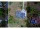 Aerial view of a home surrounded by lush greenery, showcasing its spacious layout and large driveway at 4004 Se 47Th Pl, Ocala, FL 34480