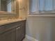 Bathroom featuring a gray vanity cabinet with marble countertop and modern faucet at 4004 Se 47Th Pl, Ocala, FL 34480