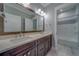 Bright bathroom features a double vanity with modern fixtures and a tub with decorative tile at 4004 Se 47Th Pl, Ocala, FL 34480
