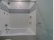 Beautiful bathtub with patterned tile, showerhead, and built in shower caddy niches at 4004 Se 47Th Pl, Ocala, FL 34480