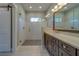 Bathroom boasting large walk-in shower with seamless glass and vanity with stone counters at 4004 Se 47Th Pl, Ocala, FL 34480