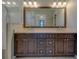 Bathroom vanity with double sinks, quartz counters, decorative backsplash and framed mirror at 4004 Se 47Th Pl, Ocala, FL 34480