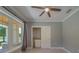 Bright bedroom showcasing closet, window, wood ceiling fan, and neutral color scheme at 4004 Se 47Th Pl, Ocala, FL 34480