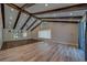 Large bonus room features wood beams, wood flooring, a ceiling fan and mirrored wall at 4004 Se 47Th Pl, Ocala, FL 34480