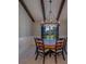 Dining room featuring a round wooden table, upholstered chairs, and a modern chandelier with beams above at 4004 Se 47Th Pl, Ocala, FL 34480