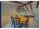 Dining room with wood-trimmed table, upholstered chairs, modern chandelier, and light-filled open floor plan at 4004 Se 47Th Pl, Ocala, FL 34480