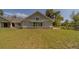 Charming home exterior featuring light green siding and a stone foundation accent at 4004 Se 47Th Pl, Ocala, FL 34480