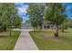 Beautiful property featuring a long driveway and well-maintained landscaping at 4004 Se 47Th Pl, Ocala, FL 34480