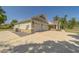 Three-car garage with stone veneer and carriage doors, offering ample parking and storage space at 4004 Se 47Th Pl, Ocala, FL 34480