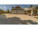 Three-car garage with stone veneer and carriage doors, complemented by a spacious driveway and manicured lawn at 4004 Se 47Th Pl, Ocala, FL 34480