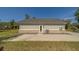 Rear view of the home featuring light green siding and a concrete patio at 4004 Se 47Th Pl, Ocala, FL 34480
