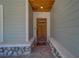 Charming front entrance featuring a craftsman-style door, brick flooring, and warm wood ceiling at 4004 Se 47Th Pl, Ocala, FL 34480