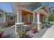 Covered front porch with wooden ceiling, white columns, stone accents, and swing at 4004 Se 47Th Pl, Ocala, FL 34480