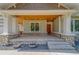 Inviting front porch with stone accents, wood ceiling, and spacious entry, providing a warm welcome at 4004 Se 47Th Pl, Ocala, FL 34480