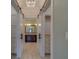 Hallway with a view into a bathroom and closet space with sliding barn doors and tile flooring at 4004 Se 47Th Pl, Ocala, FL 34480