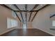 Bright living room features vaulted ceilings, wooden beams, recessed lighting, and sliding glass doors at 4004 Se 47Th Pl, Ocala, FL 34480