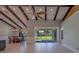 Bright living room area with wood beams and a view of the dining room at 4004 Se 47Th Pl, Ocala, FL 34480