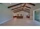 Spacious living area with striking wood beam ceilings open to the modern kitchen at 4004 Se 47Th Pl, Ocala, FL 34480
