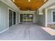 Covered patio with concrete floor, ceiling fan, and large sliding glass doors at 4004 Se 47Th Pl, Ocala, FL 34480