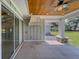 Covered outdoor patio with wood ceiling and stylish ceiling fan at 4004 Se 47Th Pl, Ocala, FL 34480