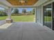 Spacious outdoor patio with concrete flooring, leading to the green backyard at 4004 Se 47Th Pl, Ocala, FL 34480