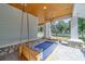 Relaxing porch swing on a spacious covered porch, perfect for enjoying the outdoors at 4004 Se 47Th Pl, Ocala, FL 34480