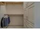 Walk-in closet with shelf and hanger rack plus floor to ceiling storage cabinet at 4004 Se 47Th Pl, Ocala, FL 34480