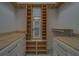 Spacious walk-in closet with custom wood shelving, drawers, and center mirror at 4004 Se 47Th Pl, Ocala, FL 34480