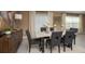 Modern dining room with decorative vases, six chairs and a large window with natural light at 4723 Golden Knight Blvd, Kissimmee, FL 34746