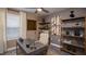Cozy home office with a comfortable chair, modern desk, and decorative shelving at 4723 Golden Knight Blvd, Kissimmee, FL 34746