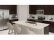 Modern kitchen with stainless steel appliances, white countertops, and a kitchen island with bar stool seating at 4723 Golden Knight Blvd, Kissimmee, FL 34746