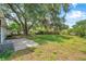The backyard features a concrete patio, grassy area, a mature tree, and an A/C unit at 1123 Enchanted Dr, Lakeland, FL 33801